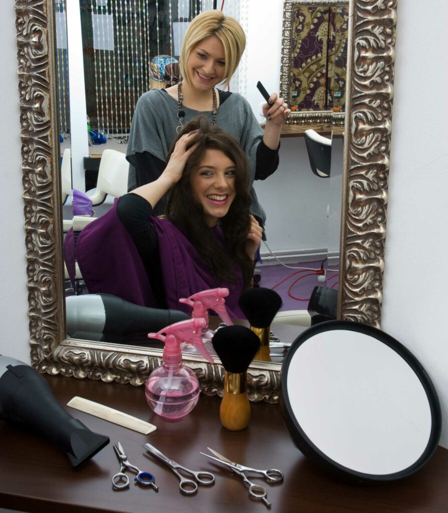 Overjoyed woman touches her full, styled hair after hair replacement.