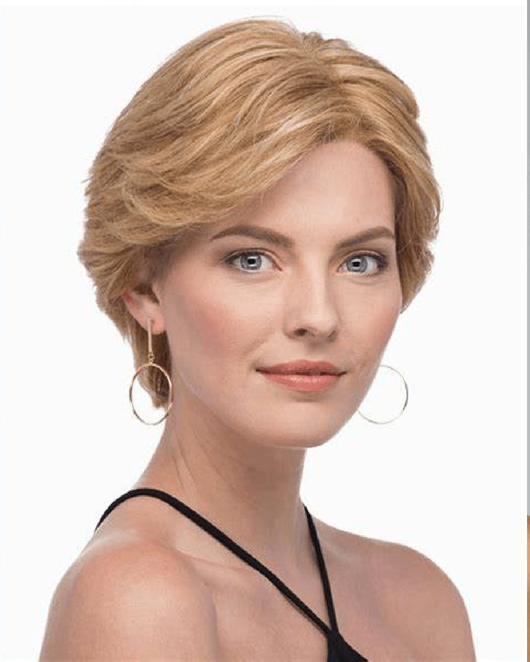 Woman wearing a short, layered human hair wig from Estetica Designs, displaying a flawless hairline, highlighting the wig's realistic appearance and superior quality.