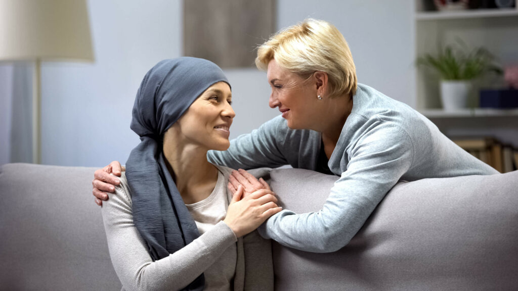 A woman supports her friend who is undergoing chemotherapy for ovarian cancer