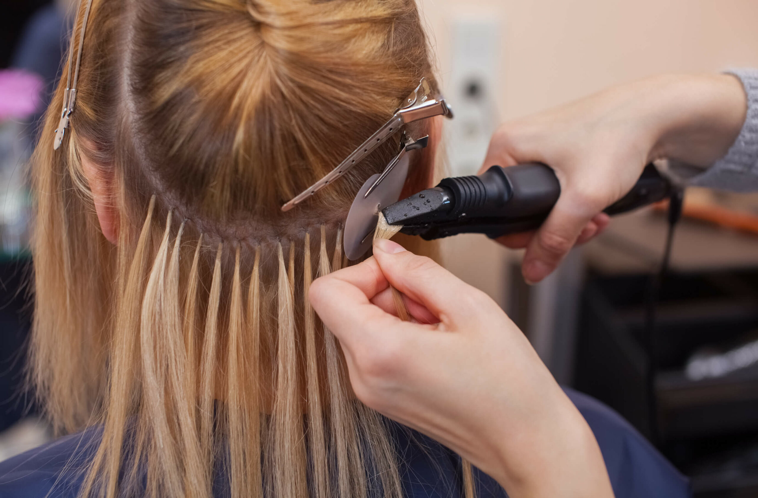 A woman getting hair extensions