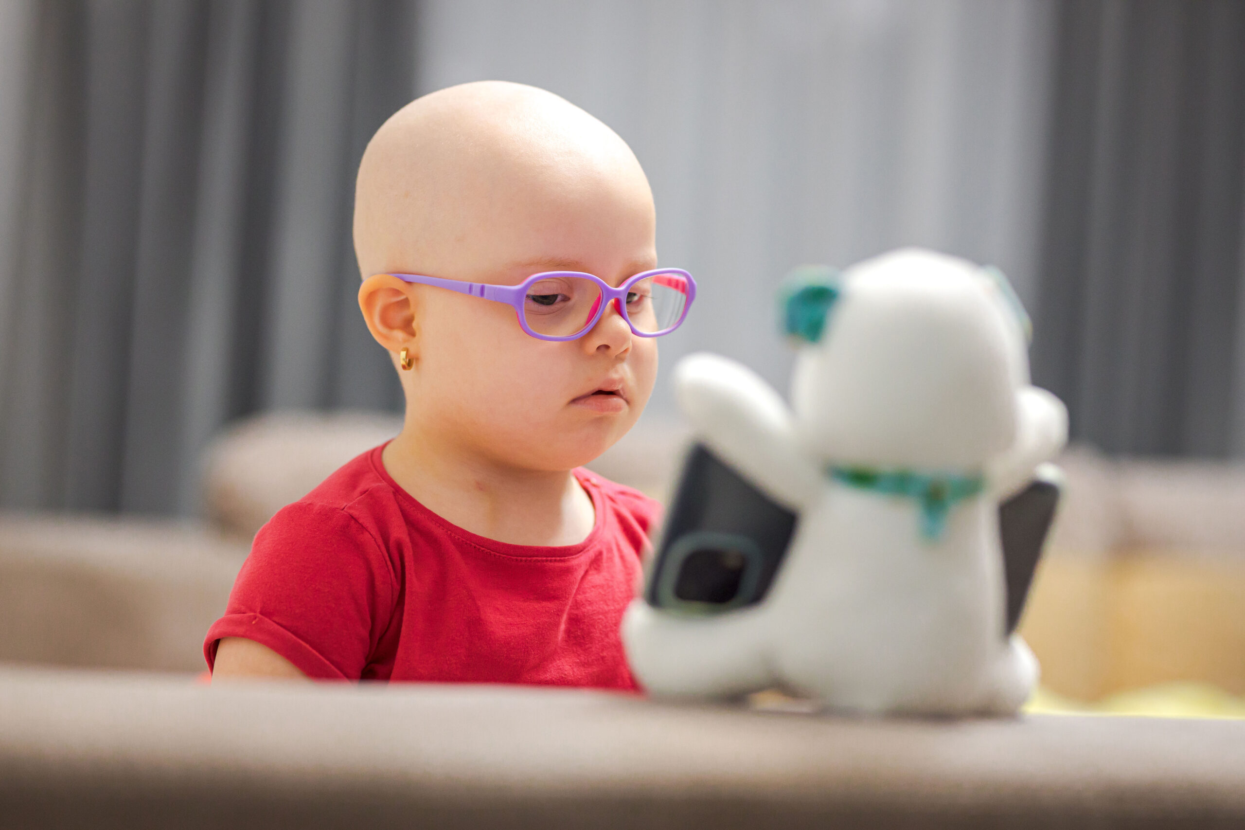 Young child with hair loss due to chemotherapy treatment for cancer or alopecia