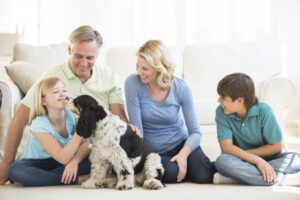 woman with her family at home with dog